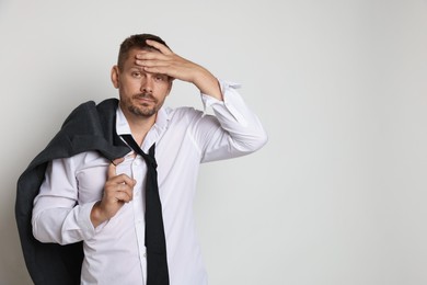 Photo of Man suffering from hangover on white background, space for text