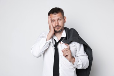 Photo of Man suffering from hangover on white background