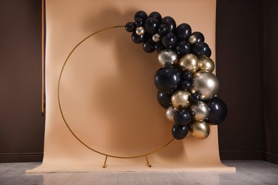 Photo of Stylish photo zone with balloons and frame in studio