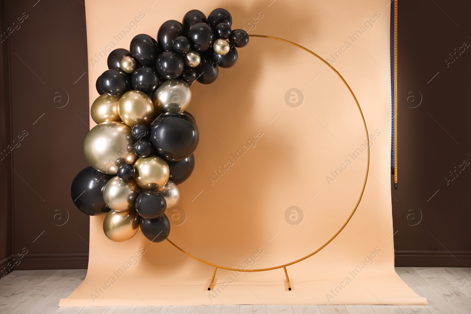 Photo of Stylish photo zone with balloons and frame in studio