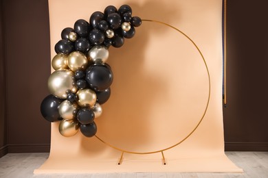 Photo of Stylish photo zone with balloons and frame in studio