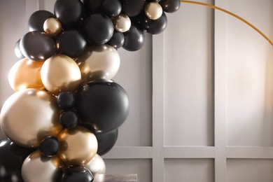 Photo of Stylish photo zone with balloons in studio, closeup. Space for text