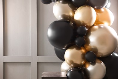 Photo of Stylish photo zone with balloons in studio, closeup. Space for text