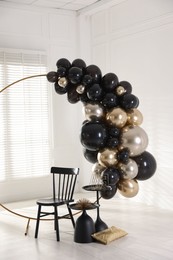 Photo of Stylish photo zone with balloons, chair and decor in studio
