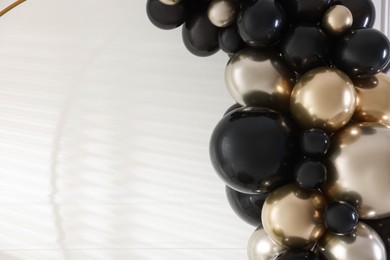 Photo of Stylish photo zone with balloons and decor in studio, closeup. Space for text