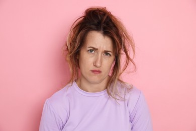 Photo of Woman suffering from hangover on pink background