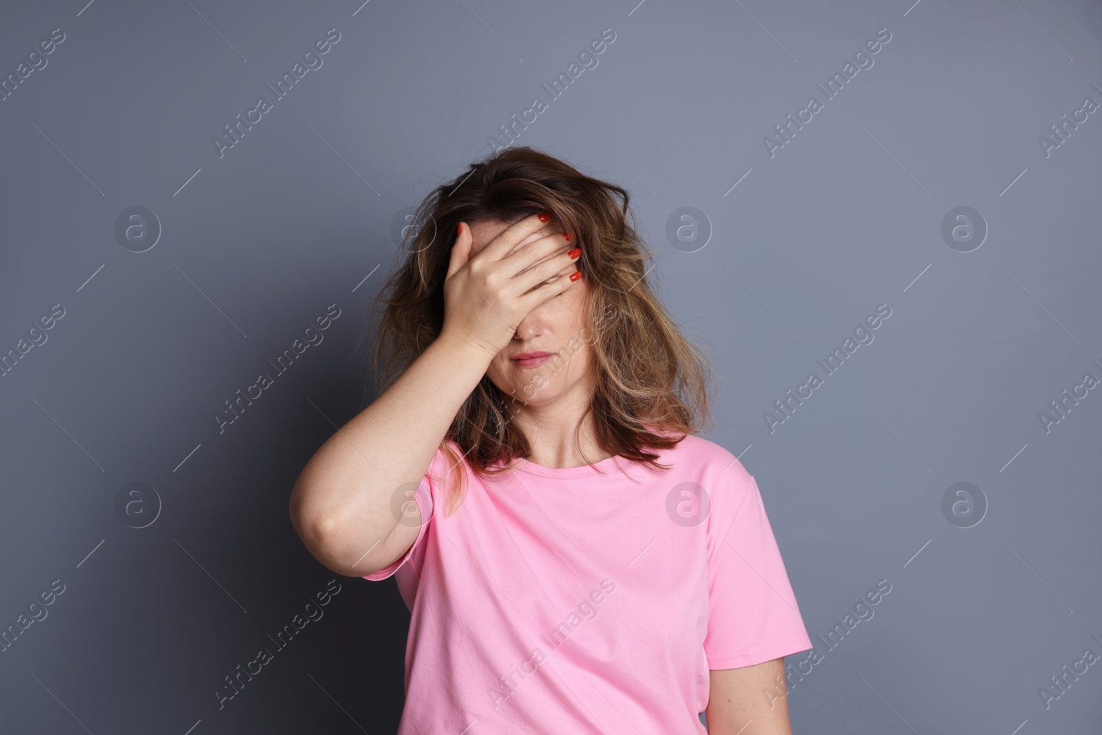 Photo of Woman suffering from hangover on grey background