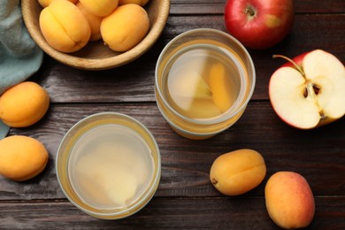 Photo of Tasty compot and fruits on wooden table, flat lay