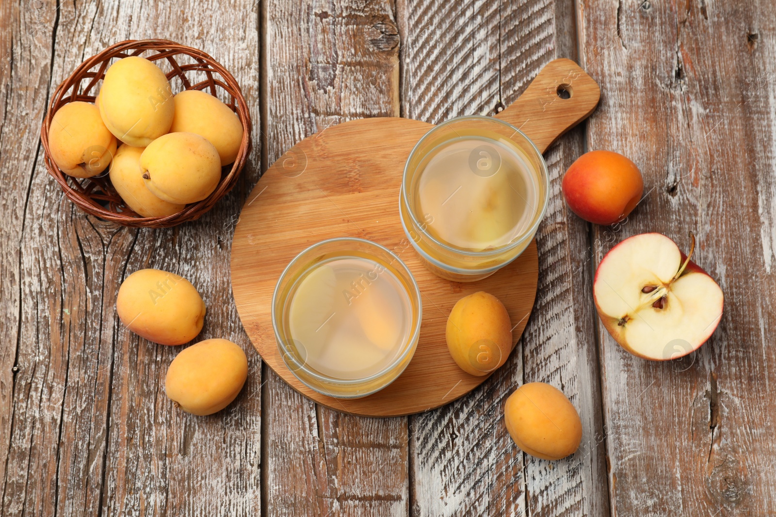 Photo of Tasty compot and fruits on wooden table, flat lay