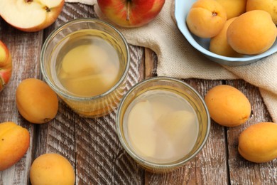 Photo of Tasty compot and fruits on wooden table, flat lay