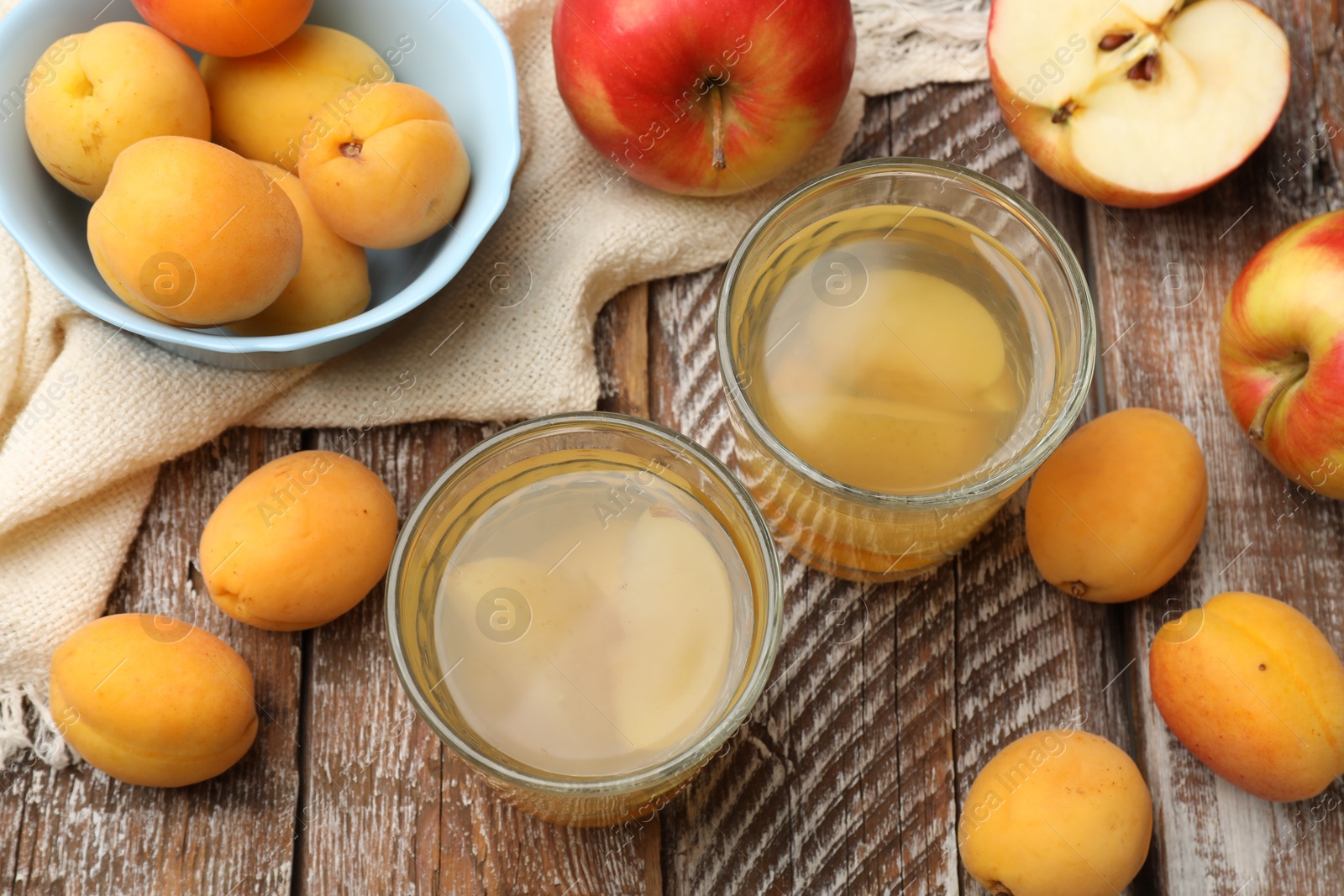 Photo of Tasty compot and fruits on wooden table, flat lay