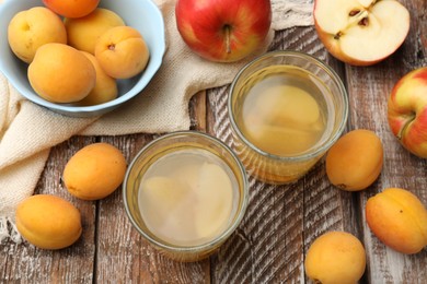 Photo of Tasty compot and fruits on wooden table, flat lay