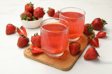 Photo of Tasty compot and strawberries on white table