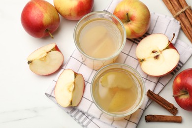 Photo of Tasty compot with apples and cinnamon on white table, flat lay