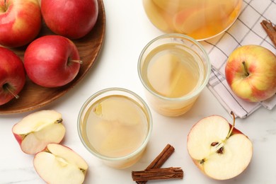 Photo of Tasty compot with apples and cinnamon on white table, flat lay