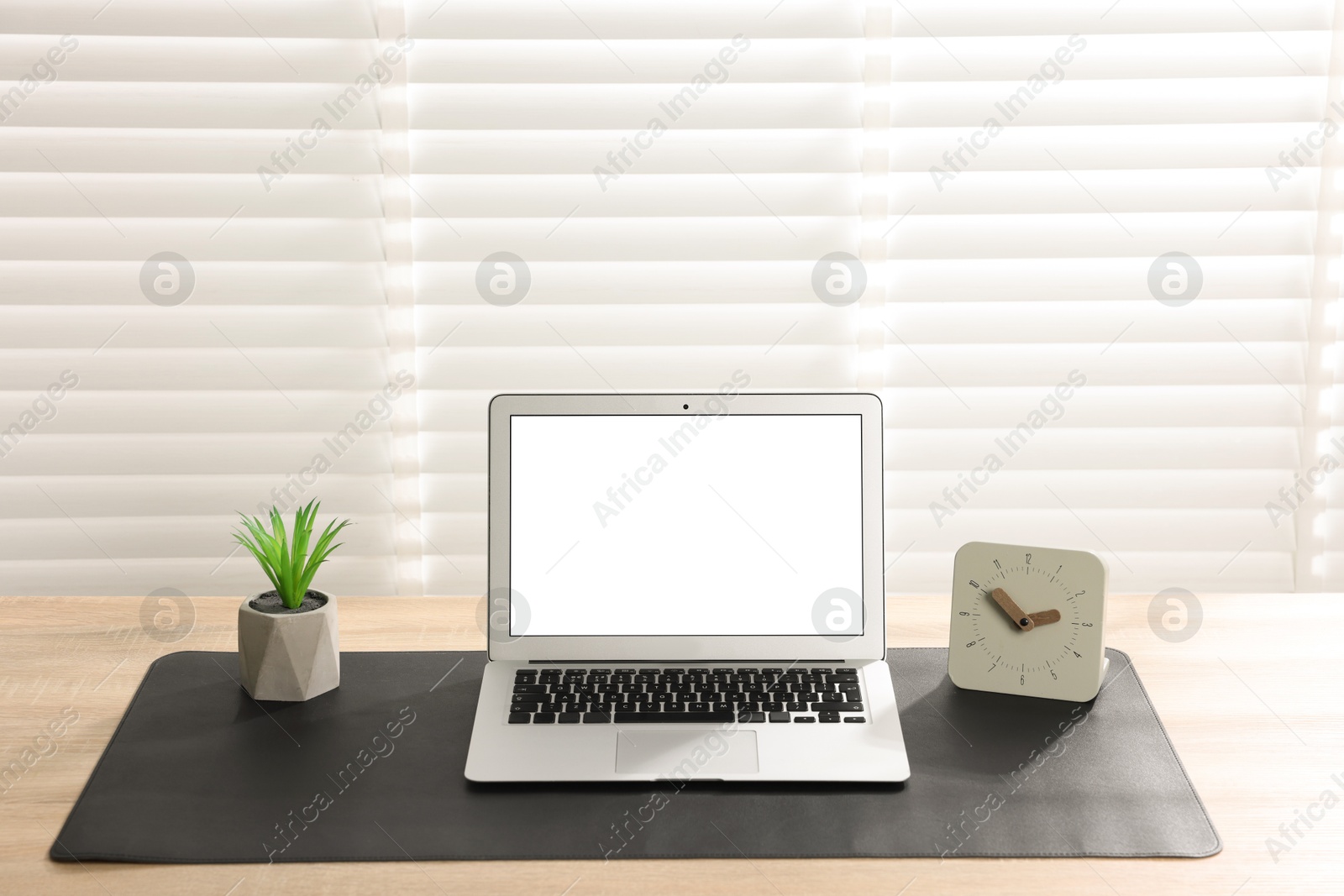 Stylish workplace with laptop and black mousepad on wooden table indoors. Space for text Photo of Stylish workplace with laptop and black mousepad on wooden table indoors. Space for text