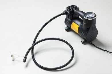 Photo of One modern tire inflator on light background