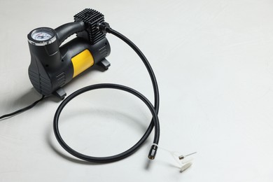 Photo of One modern tire inflator on light background