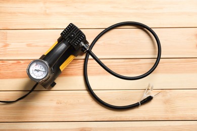 Photo of One modern tire inflator on wooden background, top view