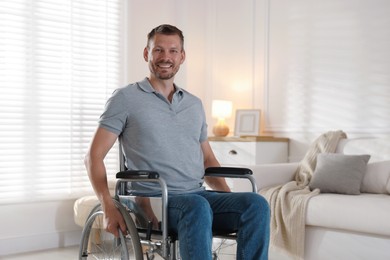 Photo of Happy man in modern wheelchair at home