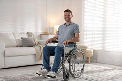 Photo of Happy man in modern wheelchair at home