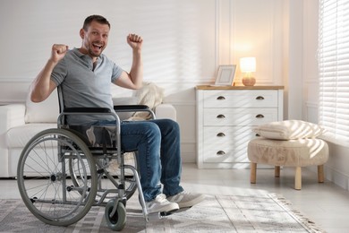 Photo of Happy man in modern wheelchair at home, space for text
