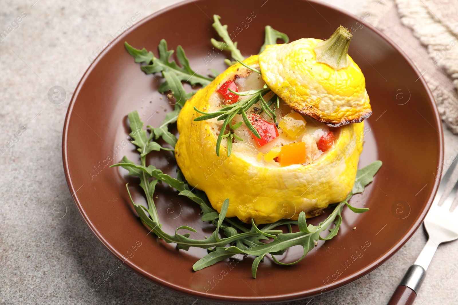 Tasty stuffed pattypan squash with arugula served on grey table, closeup Photo of Tasty stuffed pattypan squash with arugula served on grey table, closeup