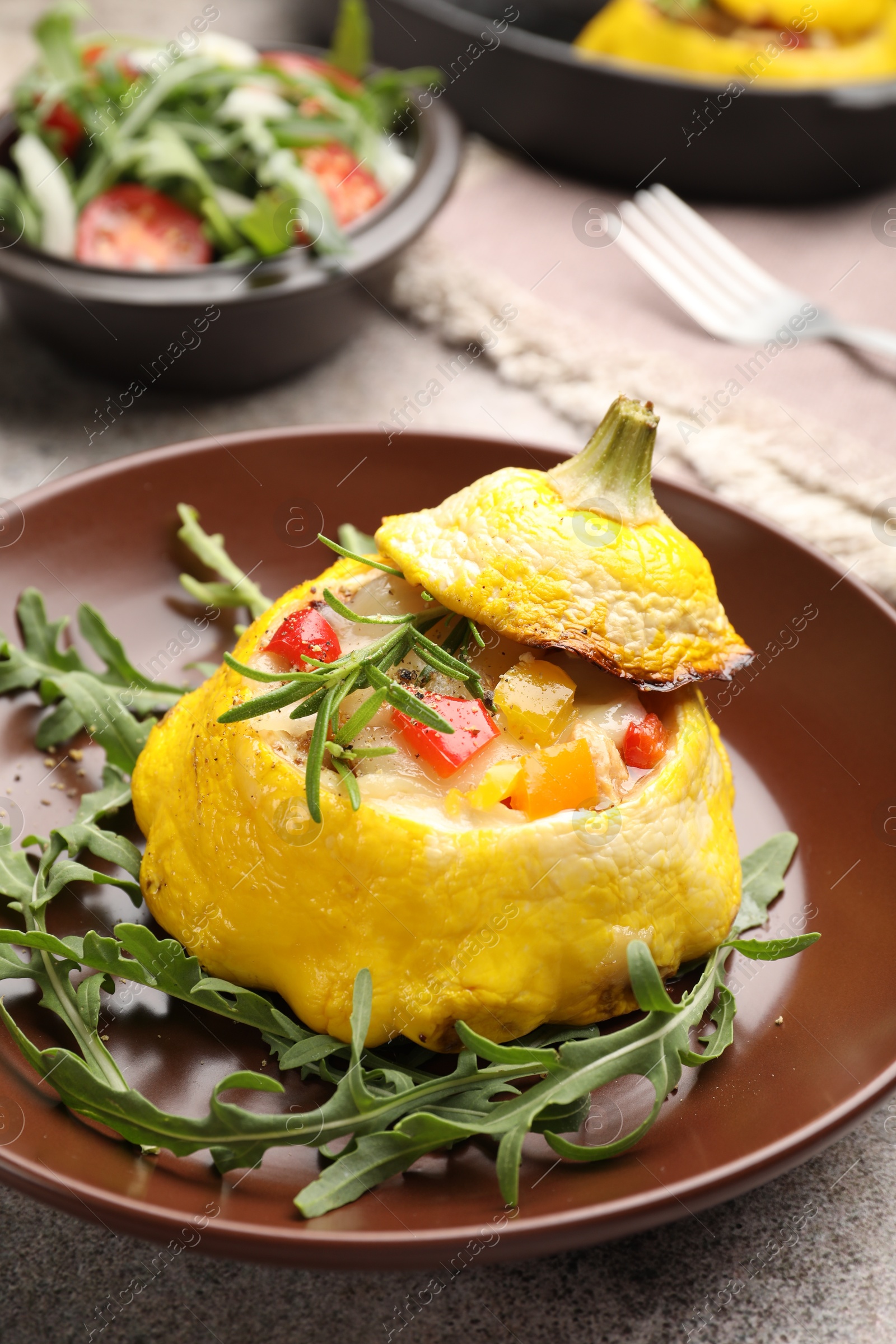 Tasty stuffed pattypan squash with arugula on grey table, closeup Photo of Tasty stuffed pattypan squash with arugula on grey table, closeup
