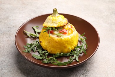 Photo of Tasty stuffed pattypan squash with arugula on grey table, closeup