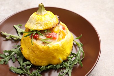 Photo of Tasty stuffed pattypan squash with arugula on grey table, closeup