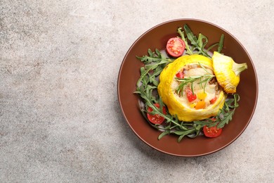 Photo of Tasty stuffed pattypan squash with tomatoes and arugula on grey table, top view. Space for text