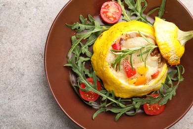 Photo of Tasty stuffed pattypan squash with tomatoes and arugula on grey table, top view