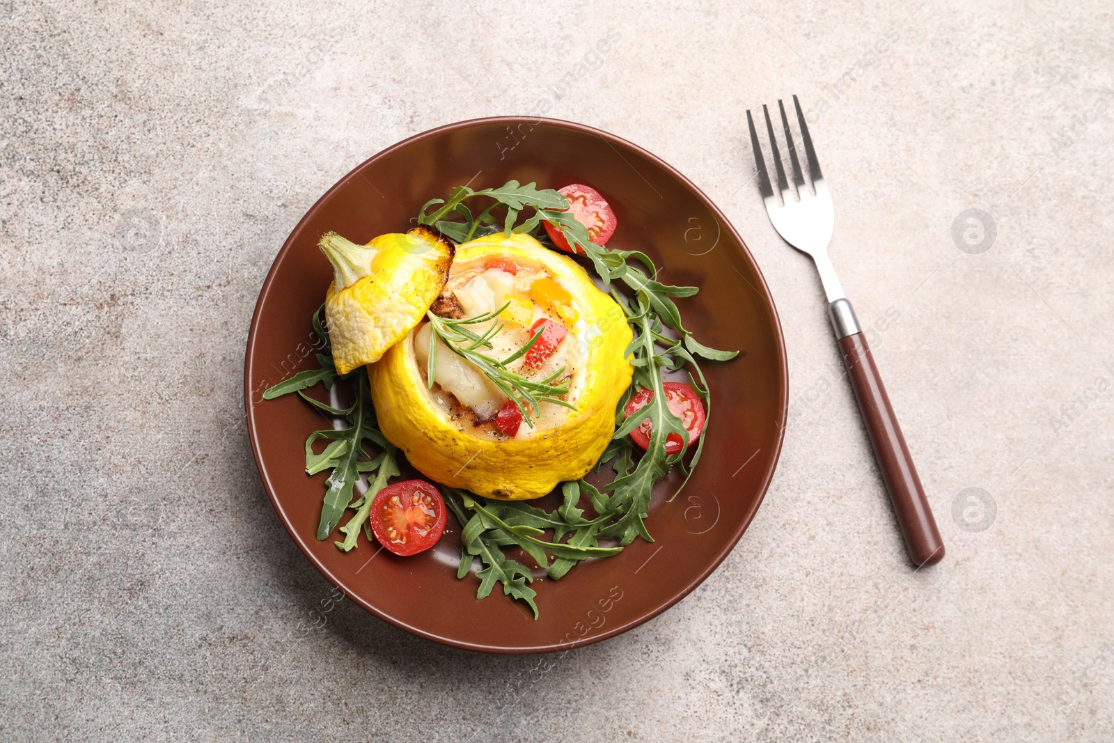 Tasty stuffed pattypan squash with tomatoes and arugula served on grey table, top view Photo of Tasty stuffed pattypan squash with tomatoes and arugula served on grey table, top view