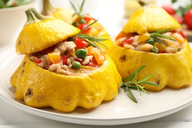 Photo of Tasty stuffed pattypan squashes on white wooden table, closeup