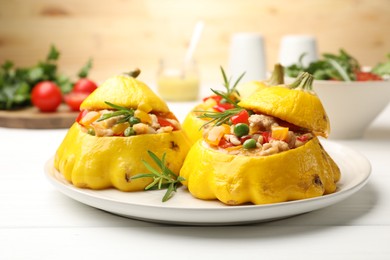 Photo of Tasty stuffed pattypan squashes on white wooden table, closeup