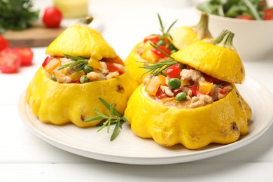 Photo of Tasty stuffed pattypan squashes on white wooden table, closeup