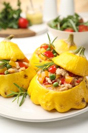 Photo of Tasty stuffed pattypan squashes on white table, closeup