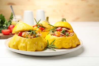 Photo of Tasty stuffed pattypan squashes on white wooden table, closeup