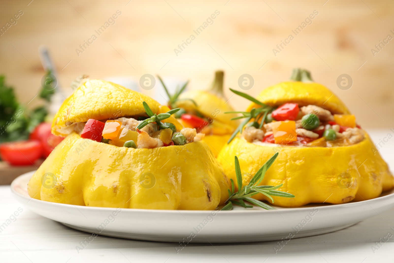 Photo of Tasty stuffed pattypan squashes on white table, closeup