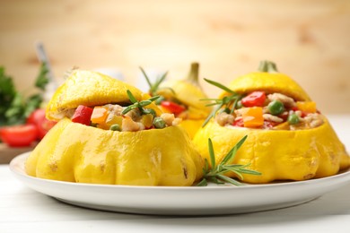 Photo of Tasty stuffed pattypan squashes on white table, closeup
