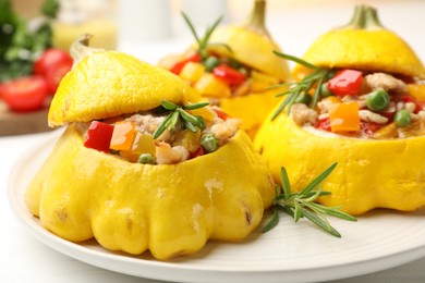Photo of Tasty stuffed pattypan squashes on white table, closeup