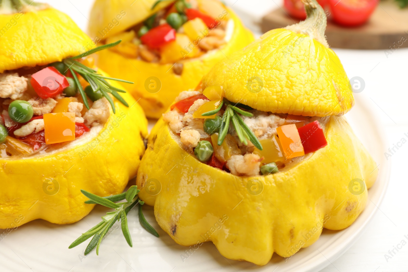 Photo of Tasty stuffed pattypan squashes on white table, closeup