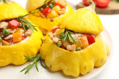 Photo of Tasty stuffed pattypan squashes on white table, closeup