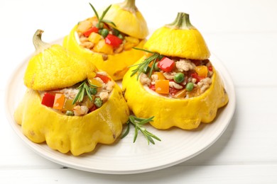 Photo of Tasty stuffed pattypan squashes on white wooden table, closeup