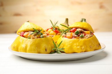 Photo of Tasty stuffed pattypan squashes on white wooden table, closeup