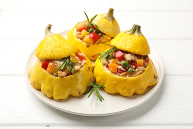 Photo of Tasty stuffed pattypan squashes on white wooden table, closeup
