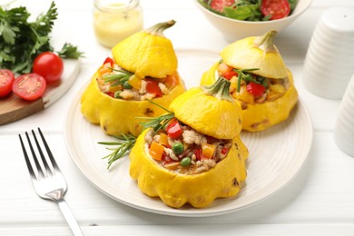 Photo of Tasty stuffed pattypan squashes on white wooden table, closeup