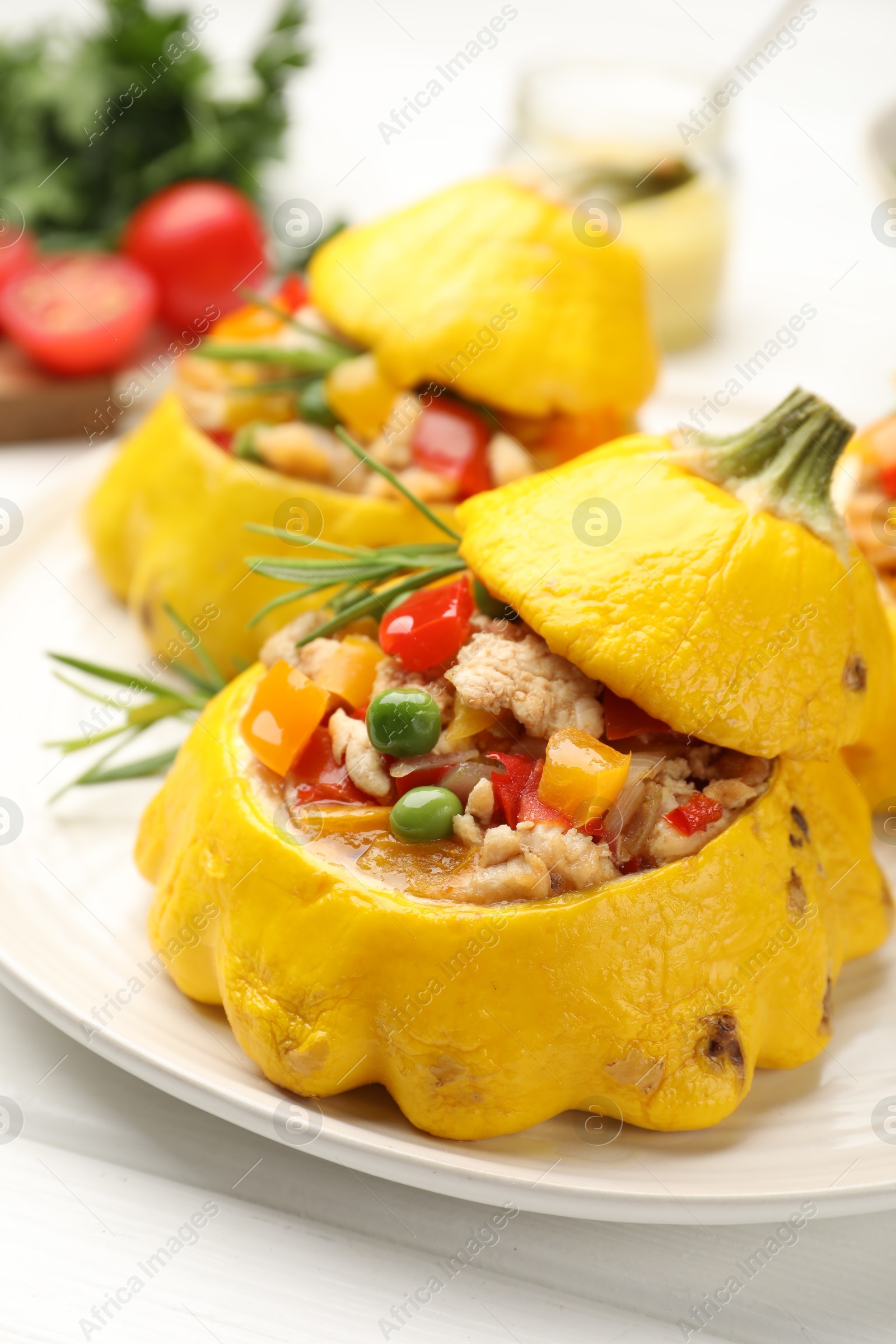 Photo of Tasty stuffed pattypan squashes on white table, closeup