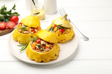 Photo of Tasty stuffed pattypan squashes on white wooden table, closeup