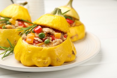 Photo of Tasty stuffed pattypan squashes on white wooden table, closeup